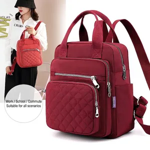 Burgundy nylon backpack with quilted diamond stitching and multi-zippered pockets for women