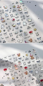 Macro detail of laser holographic nail stickers featuring cute puppy and bow designs