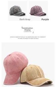 Detail view of washed cotton baseball caps in dark grey, purple, pink, and beige colors