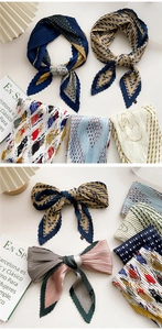 Detail of pleated silk scarf showing micro-accordion folds and various artistic patterns