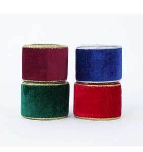 Close-up of velvet Christmas ribbons with metallic edges in four festive colors