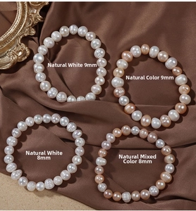 Close-up of 8mm and 9mm natural freshwater pearls on elegant dark silk fabric