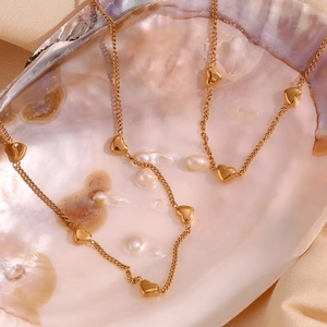 Macro view of gold-plated heart pendant necklace inside a shimmering seashell