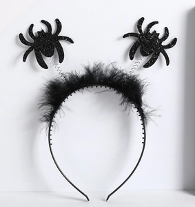 Detail of black Halloween headband with springy spiders and soft feather accents
