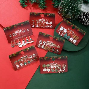 Detailed set of Christmas earrings featuring Santa, reindeer, and festive bells