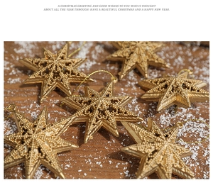 Detailed close-up of golden hollowed Christmas star ornaments on a rustic wooden background
