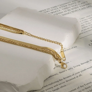 Detail of layered gold stainless steel chains with S.Steel engraving and lobster clasp