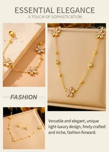 Detail of gold flower jewelry set with clear crystals on beige display pedestals