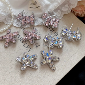 Detailed close-up of sparkling rhinestone puppy and star hair clips with elegant bow details