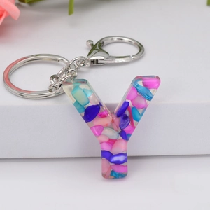 Letter Y resin keychain with colorful pink and blue stones on white background