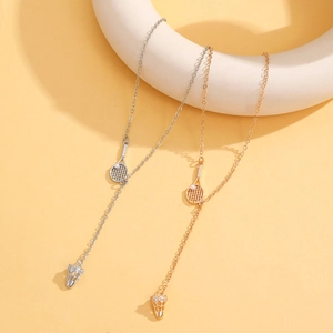 Detail of gold and silver tennis racket pendant necklaces with tassel shuttles