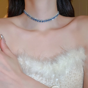 Nahaufnahme einer blauen Strass-Halskette an einem Modell mit elegantem Design