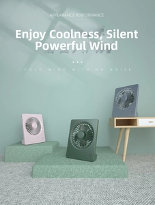 Three desktop USB fans in pink, green, and blue on a modern minimalist platform