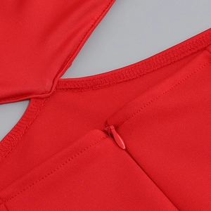 Macro shot of invisible zipper and overlock stitching on red off-shoulder feather dress