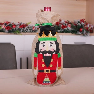 Detailed view of nutcracker wine bottle bag made of natural linen with green ribbon bow