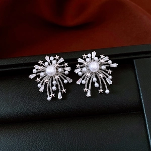 Macro shot of 18k gold plated firework studs with pearls and sparkling cubic zirconia