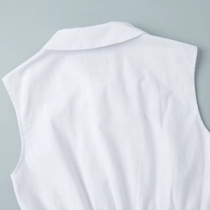 Detailed macro view of white vest top's turnover collar and premium linen texture