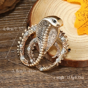 Golden cobra snake brooch with clear rhinestones on wood slice, size 4.0cm x 3.8cm details