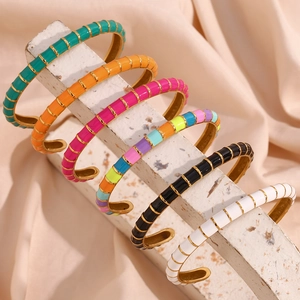 Detail view of colorful enamel 18K gold plated stainless steel open bangles for women