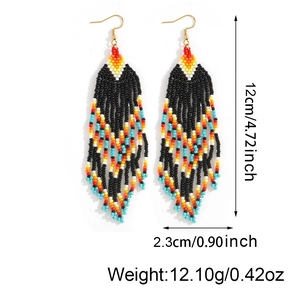 Handmade Bohemian beaded tassel earrings with colorful geometric patterns on white backdrop