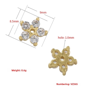 Detailed view of 18K gold flower charm with micro-paved zircons for DIY jewelry making