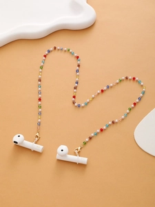 Detailed view of colorful acrylic beaded headphone chain with metal clasps on cloud prop