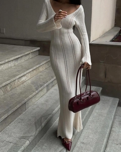 Detail of elegant cream v-neck knit maxi dress showing openwork texture and long sleeves