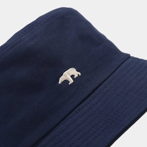 Navy blue bucket hat with detailed polar bear embroidery on high-quality cotton fabric