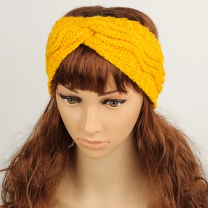 Macro detail of yellow cable knit headband showing thick yarn texture and twist knot
