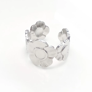 Detail of silver floral stainless steel open ring with interlocking flower pattern