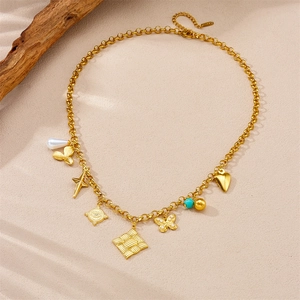 Vintage stainless steel necklace with gold pendants featuring heart, butterfly and eye charms
