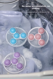 Detailed view of colorful floating laundry lint filters inside a washing machine