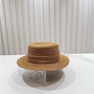 Classic French flat top straw sun hat with decorative ribbon for beach vacation