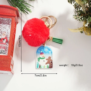 Christmas snowman keychain with red faux fur ball and green tassel on white background