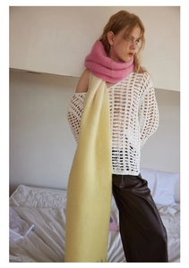 Close-up of soft pink and yellow gradient wool scarf with fluffy knit texture
