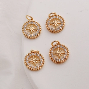 Detailed macro view of four 14K gold plated star charms with shimmering cubic zirconia inlay