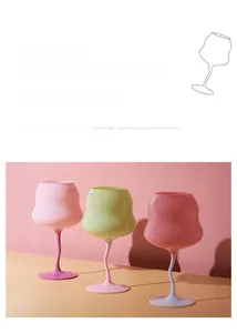 Close-up of three colorful matte glass goblets with unique wavy twisted stems in candy tones