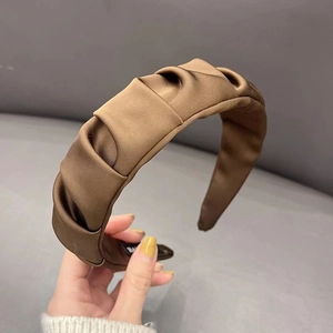 Detailed close-up of coffee brown pleated satin headband showing silky texture and fabric