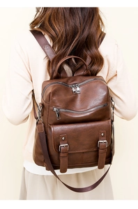 Detailed view of the brown vintage soft leather backpack with stylish tassel and zippers