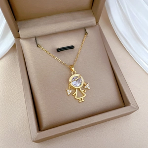 Detail of gold girl pendant necklace with crystal accents in a beige jewelry gift box
