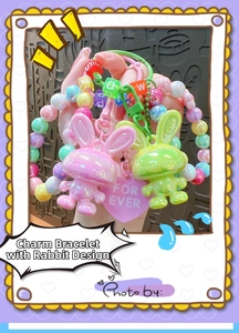 Close-up of colorful acrylic bunny charms with macaron beads and heart-shaped pendants