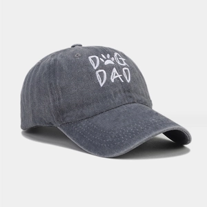 Detailed close-up of embroidered DOG DAD text and paw print on washed cotton baseball cap