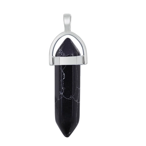 Macro shot of a black natural stone hexagonal point pendant with silver metal clasp