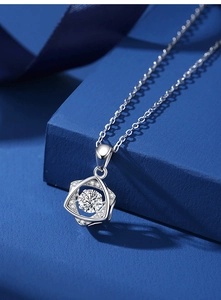 Close-up of S925 sterling silver hexagram necklace with moissanite on a blue background