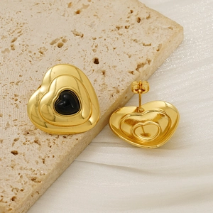 Polished gold heart-shaped stud earrings with tiered design and black enamel centers