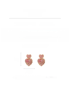 Detail view of pink heart earrings featuring sparkling rhinestones and enamel finish