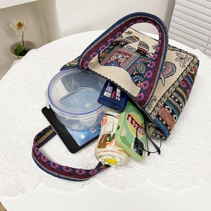 Detailed embroidery on canvas tote bag with elephant patterns and colorful stripes