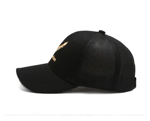 Detailed side view of black baseball cap featuring gold Freedom embroidery and mesh back