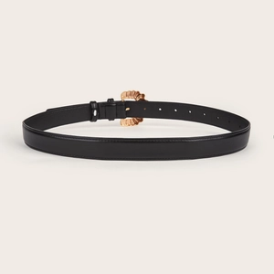 Chic women's black leather belt featuring a decorative wave-shaped gold buckle
