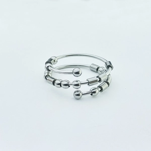 Detail of silver stainless steel fidget ring with rotatable beads for anxiety relief